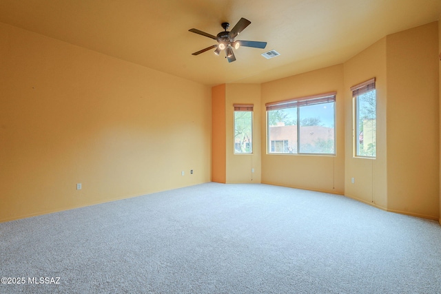 carpeted empty room featuring ceiling fan