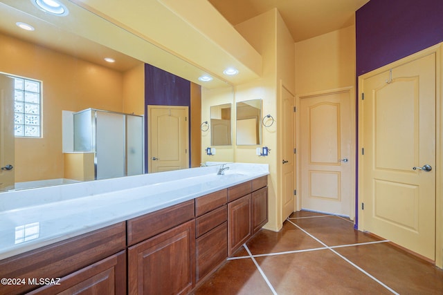 bathroom featuring tile patterned floors, vanity, and an enclosed shower