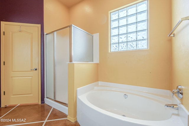 bathroom featuring tile patterned floors and independent shower and bath