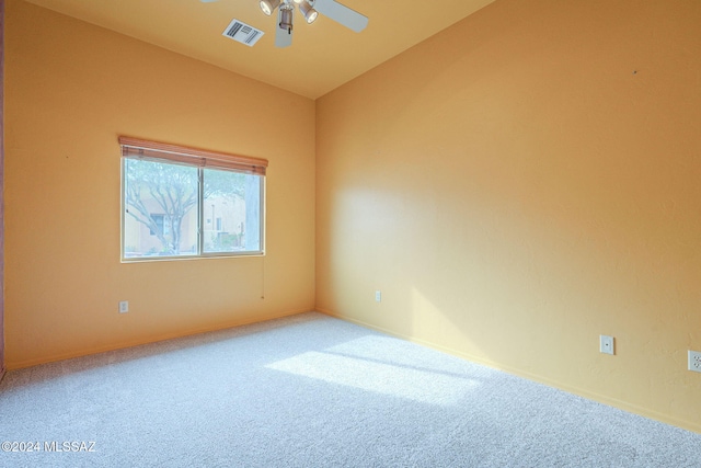 carpeted empty room with ceiling fan and vaulted ceiling