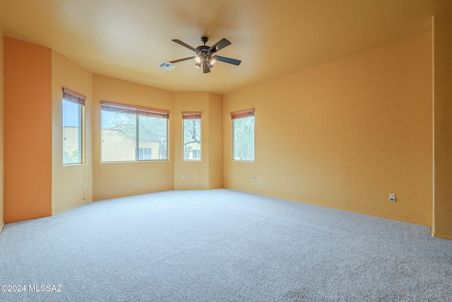 unfurnished room with carpet and ceiling fan