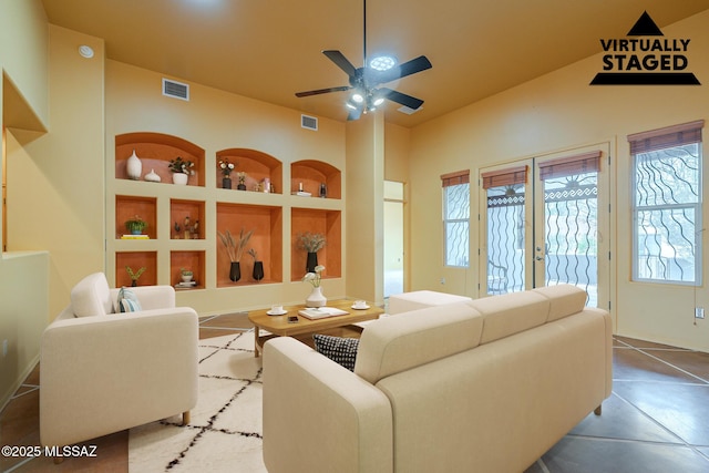 living room with ceiling fan, built in features, and french doors