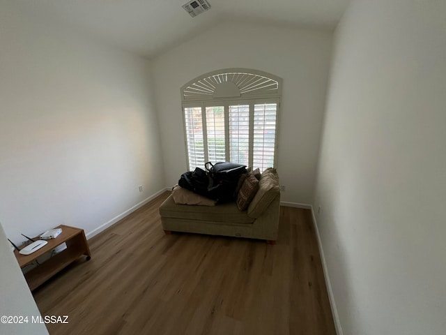 living room with lofted ceiling and hardwood / wood-style flooring