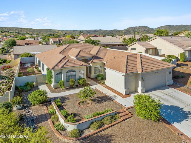 view of front of property featuring a mountain view and a garage