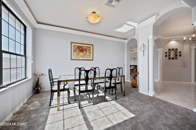 dining area featuring a chandelier, carpet floors, ornate columns, and ornamental molding