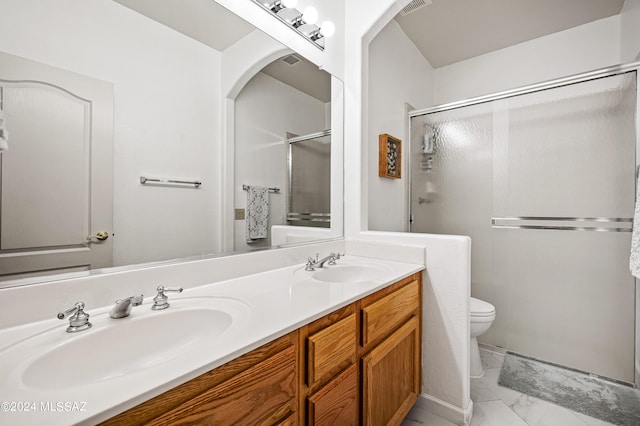 bathroom with vanity, a shower with shower door, and toilet