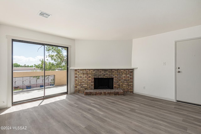 unfurnished living room with a fireplace and hardwood / wood-style flooring