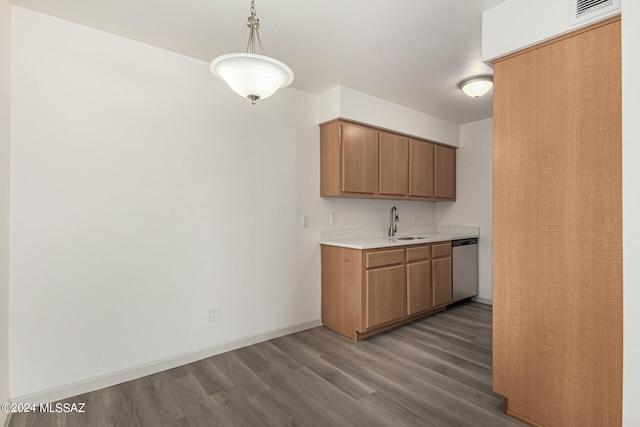 kitchen with dark hardwood / wood-style floors, dishwasher, sink, and decorative light fixtures