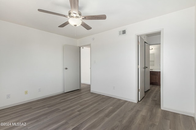 unfurnished bedroom featuring ceiling fan, dark hardwood / wood-style flooring, and ensuite bathroom