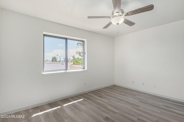 spare room featuring hardwood / wood-style floors and ceiling fan