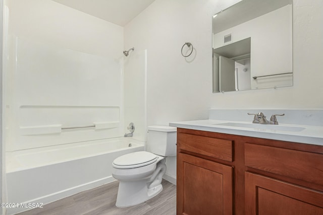 full bathroom featuring vanity, wood-type flooring,  shower combination, and toilet