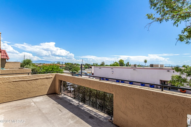 view of patio with a mountain view and a balcony