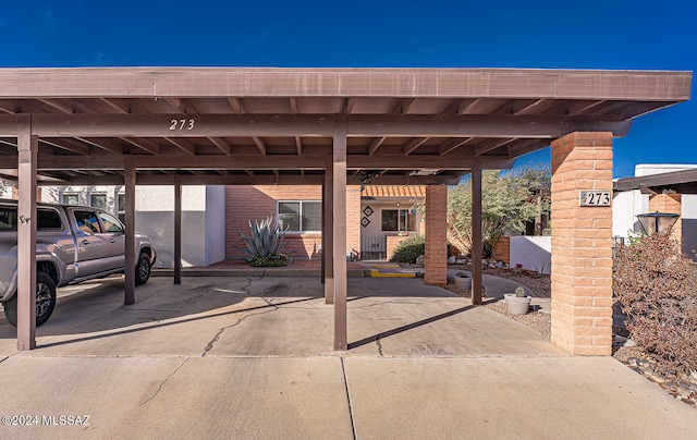 view of vehicle parking with a carport