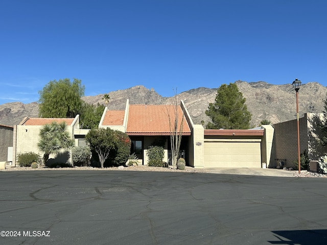 view of front of home featuring a mountain view and a garage