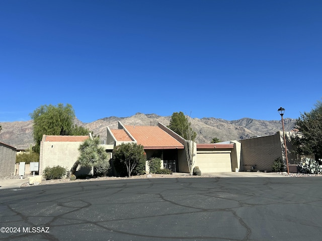 view of front facade with a mountain view and a garage