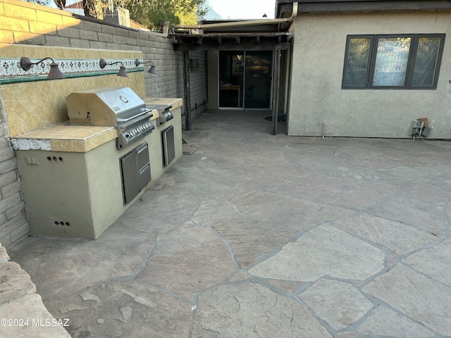 view of patio / terrace with area for grilling and a grill