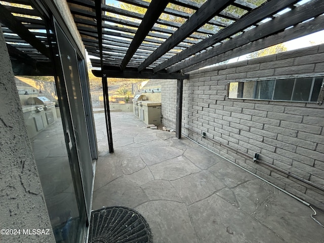 view of patio featuring a pergola and exterior kitchen