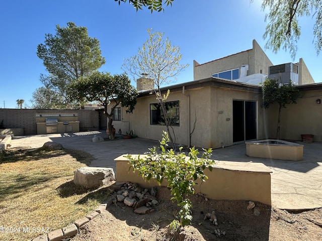 back of house featuring exterior kitchen and a patio