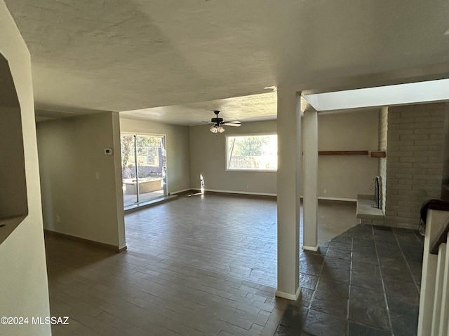 unfurnished living room with ceiling fan