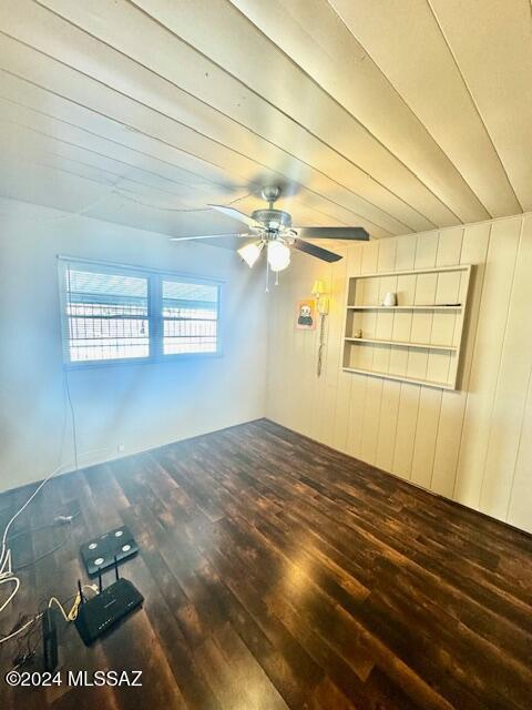 spare room with ceiling fan and dark hardwood / wood-style flooring