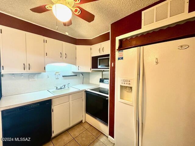 kitchen with electric range, stainless steel microwave, sink, white fridge with ice dispenser, and black dishwasher