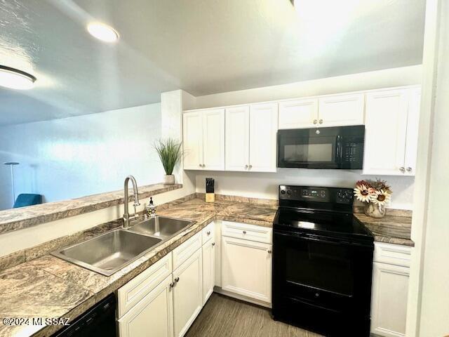 kitchen featuring white cabinets, sink, dark wood-type flooring, and black appliances