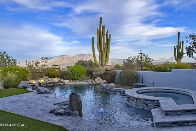 view of swimming pool with an in ground hot tub and a patio