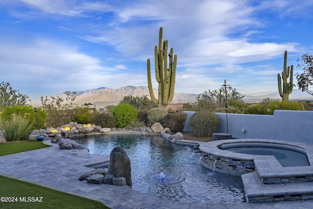 view of pool with a patio, a mountain view, an in ground hot tub, fence, and a fenced in pool