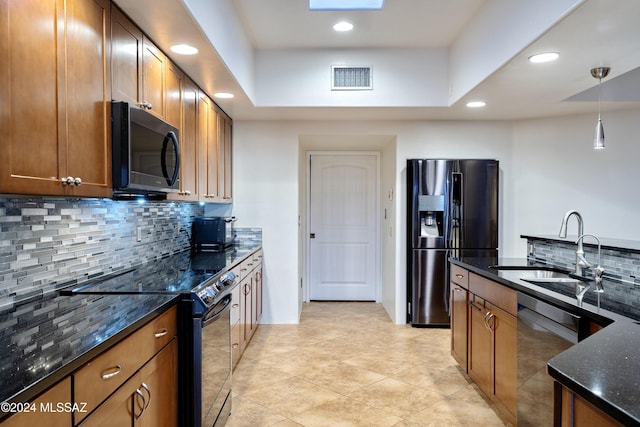 kitchen with black appliances, visible vents, brown cabinets, and a sink