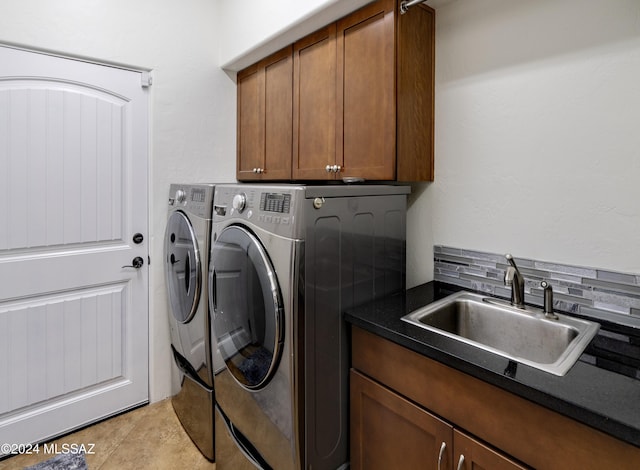 laundry room featuring a sink, cabinet space, and washer and dryer