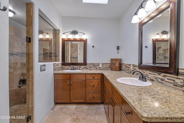 bathroom with double vanity, decorative backsplash, and a sink