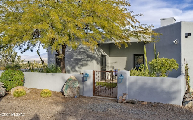 view of gate with a fenced front yard