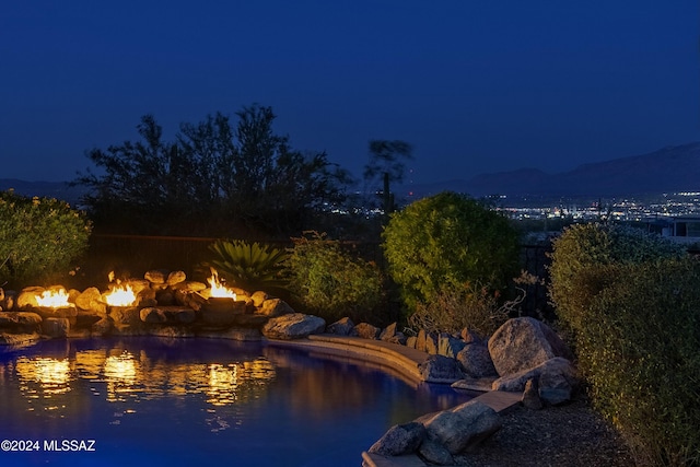 view of pool at twilight