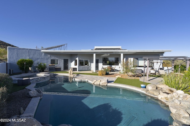 rear view of property with roof mounted solar panels, an outdoor pool, a patio, and an in ground hot tub