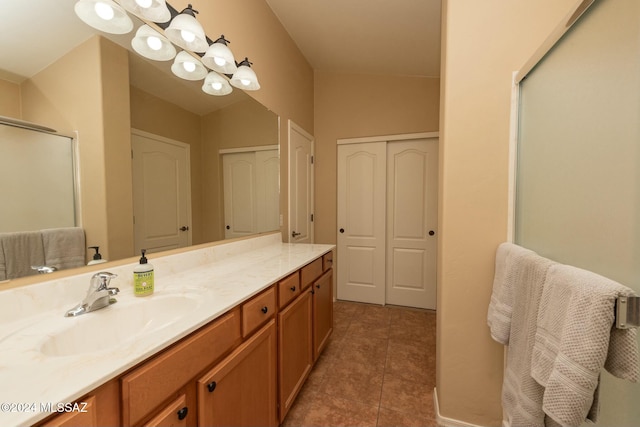 bathroom with tile patterned floors, vanity, a shower with shower door, and vaulted ceiling