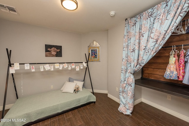 bedroom with dark hardwood / wood-style flooring