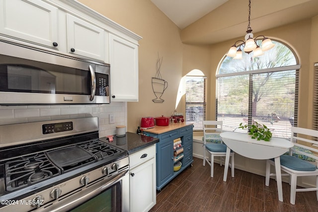 kitchen with blue cabinetry, appliances with stainless steel finishes, dark hardwood / wood-style flooring, and white cabinetry