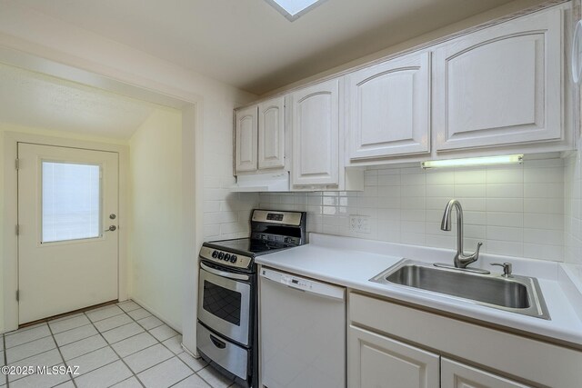 kitchen featuring sink, tasteful backsplash, white dishwasher, stainless steel electric stove, and light tile patterned floors