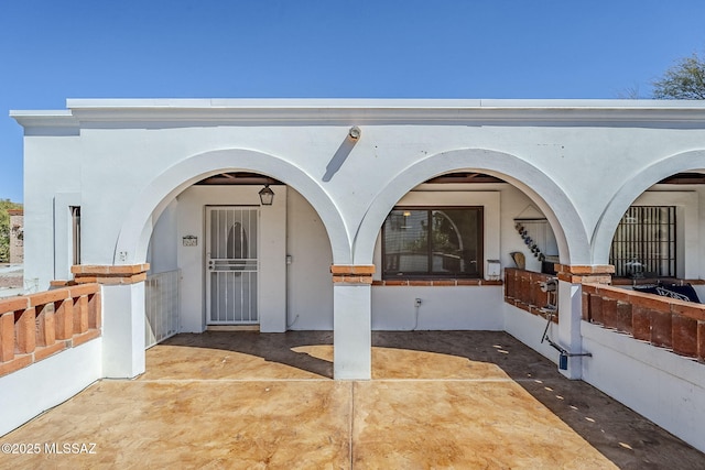 property entrance with stucco siding