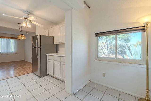 kitchen featuring stainless steel refrigerator, white cabinetry, ceiling fan, light hardwood / wood-style flooring, and vaulted ceiling