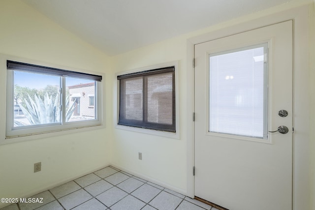 interior space featuring light tile patterned floors and lofted ceiling