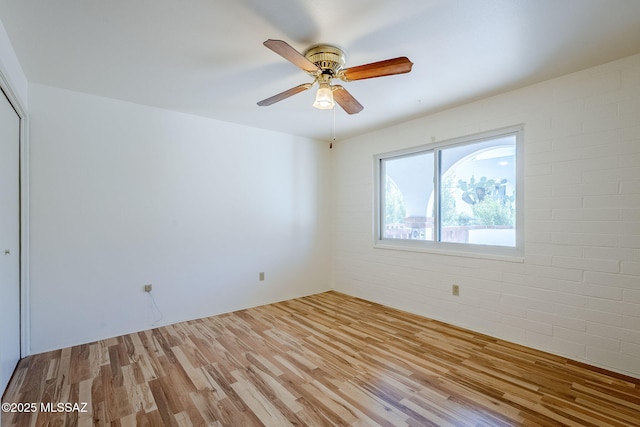 spare room featuring ceiling fan and wood finished floors
