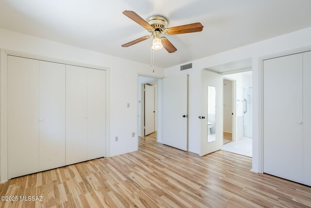 bathroom featuring walk in shower, tile patterned flooring, vanity, and toilet