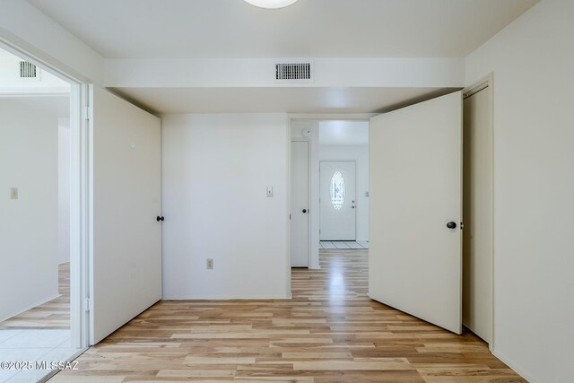 unfurnished room with light wood-type flooring