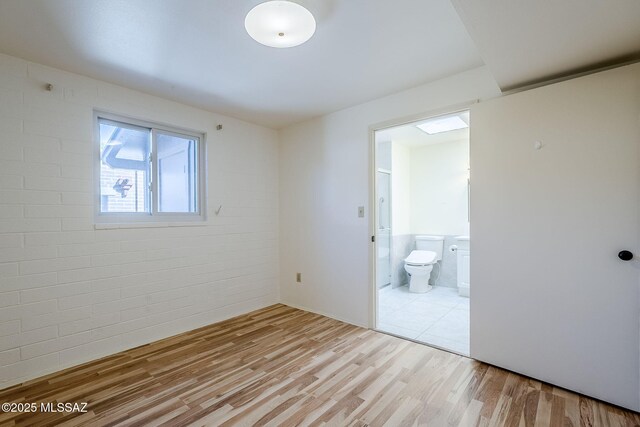 unfurnished room with light wood-type flooring