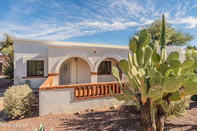 view of front of home featuring stucco siding and a porch