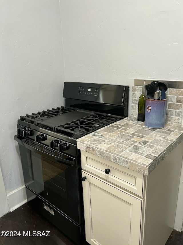 kitchen with cream cabinets and black gas stove