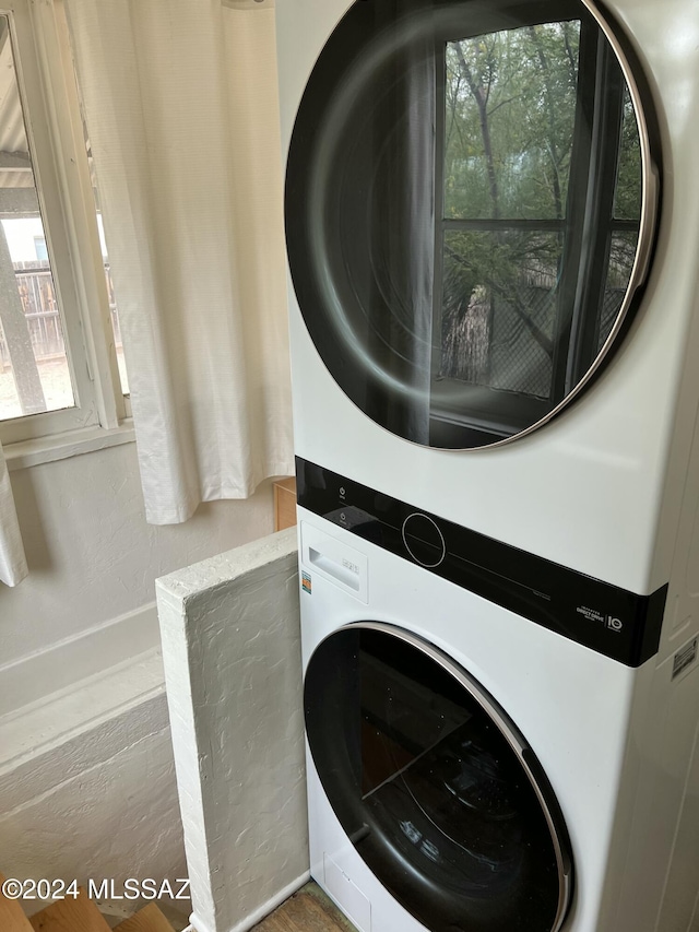 clothes washing area with stacked washer / drying machine