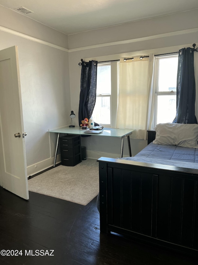 bedroom featuring dark hardwood / wood-style flooring