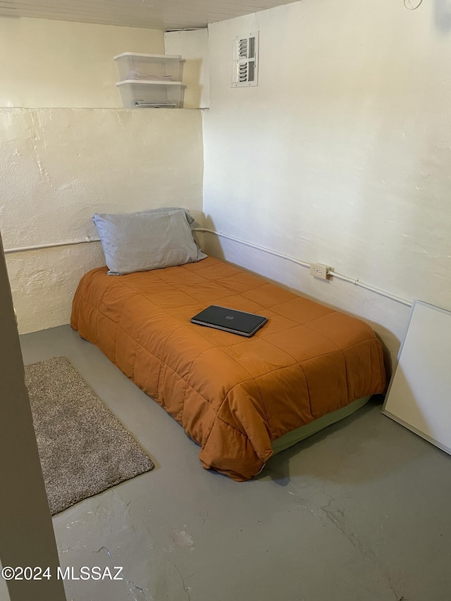 bedroom with concrete flooring